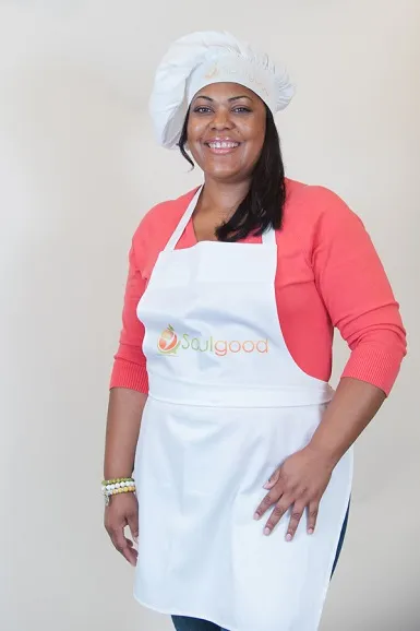 A portrait of Cynthia Nevels in a chef hat and apron.