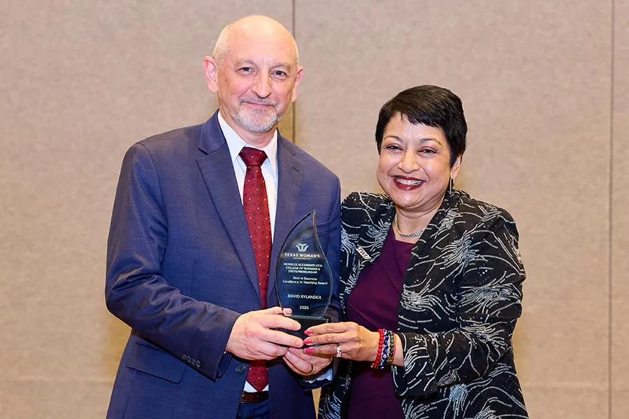 David Rylander stands next to Dean Yelkur with award in hand