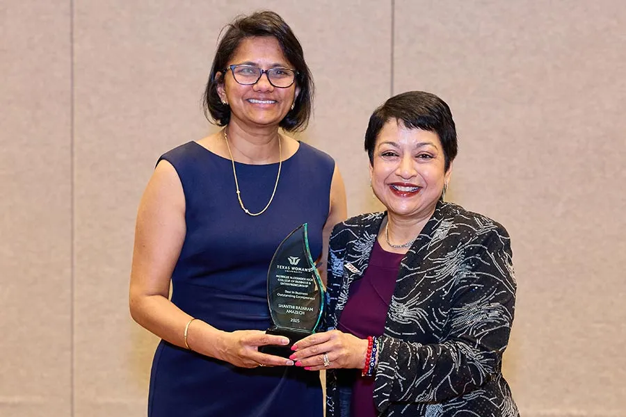 Shanthi Rajaram stands next to Dean Yelkur with award