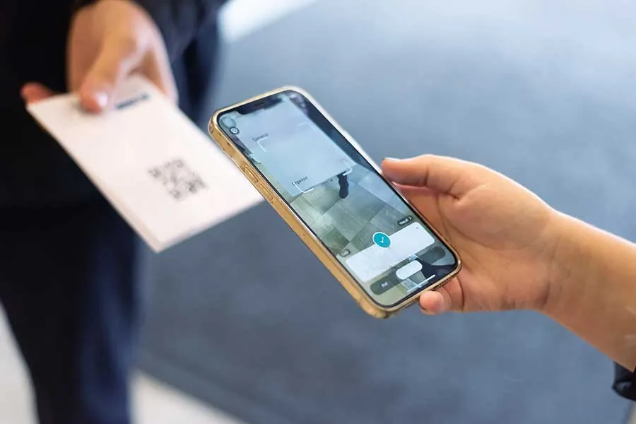 A closeup of a phone scanning a ticket.