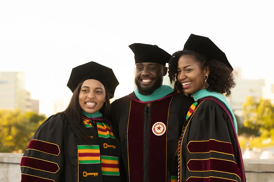 Three graduate students posing for photo