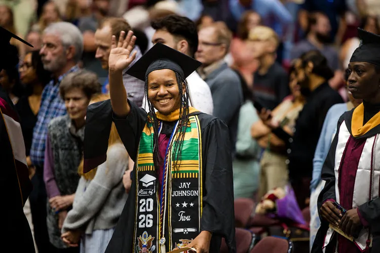 A Student Waving hand at graduation ceremony
