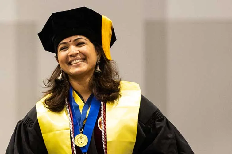 A TWU Graduate Student Smiling during the Ceremony