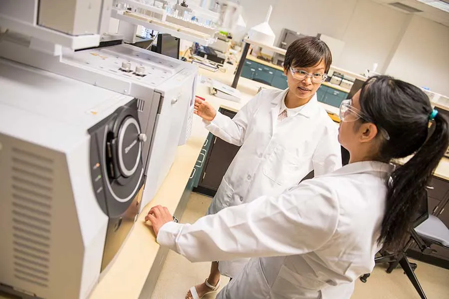 A TWU professor and student working in a nutrition lab setting.