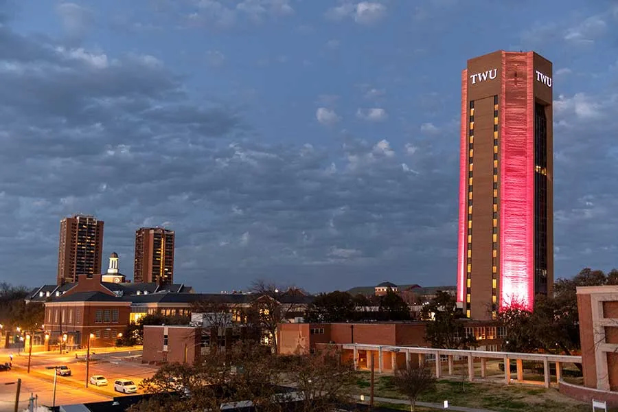 TWU skyline with the TWU tower lit up with maroon lights.