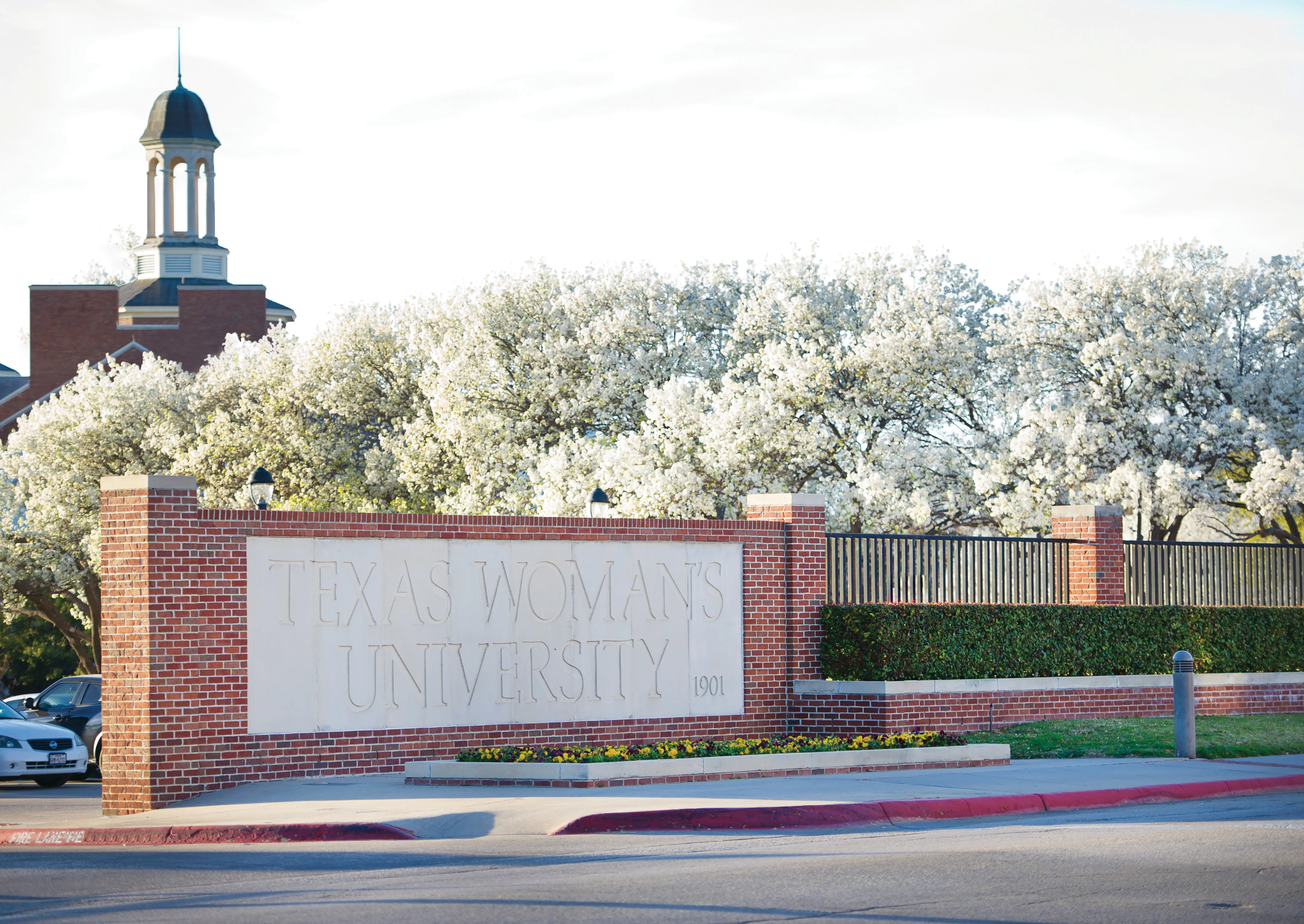 TWU sign with white flowers