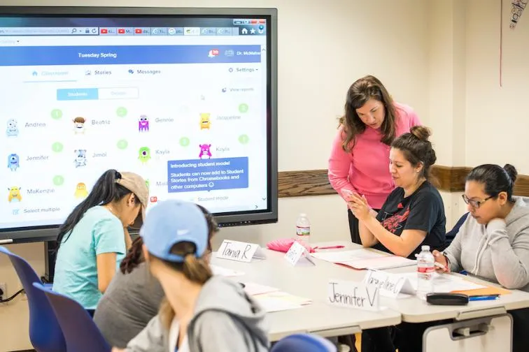A teacher helps a student in a teaching lab