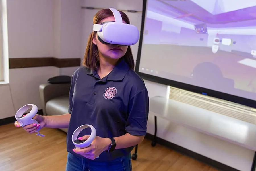 A TWU students works in virtual reality