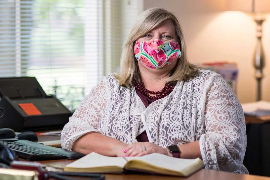 Lisa Huffman, masked at her desk, encourages public to have grace for teachers