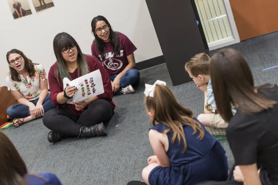 A TWU student teaches to young kids in a speech-language pathology summer camp. 