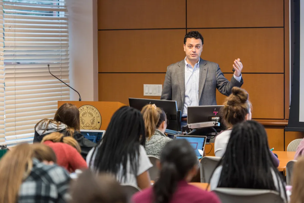 Dr. Parker Hevron lecturing in a TWU classroom.