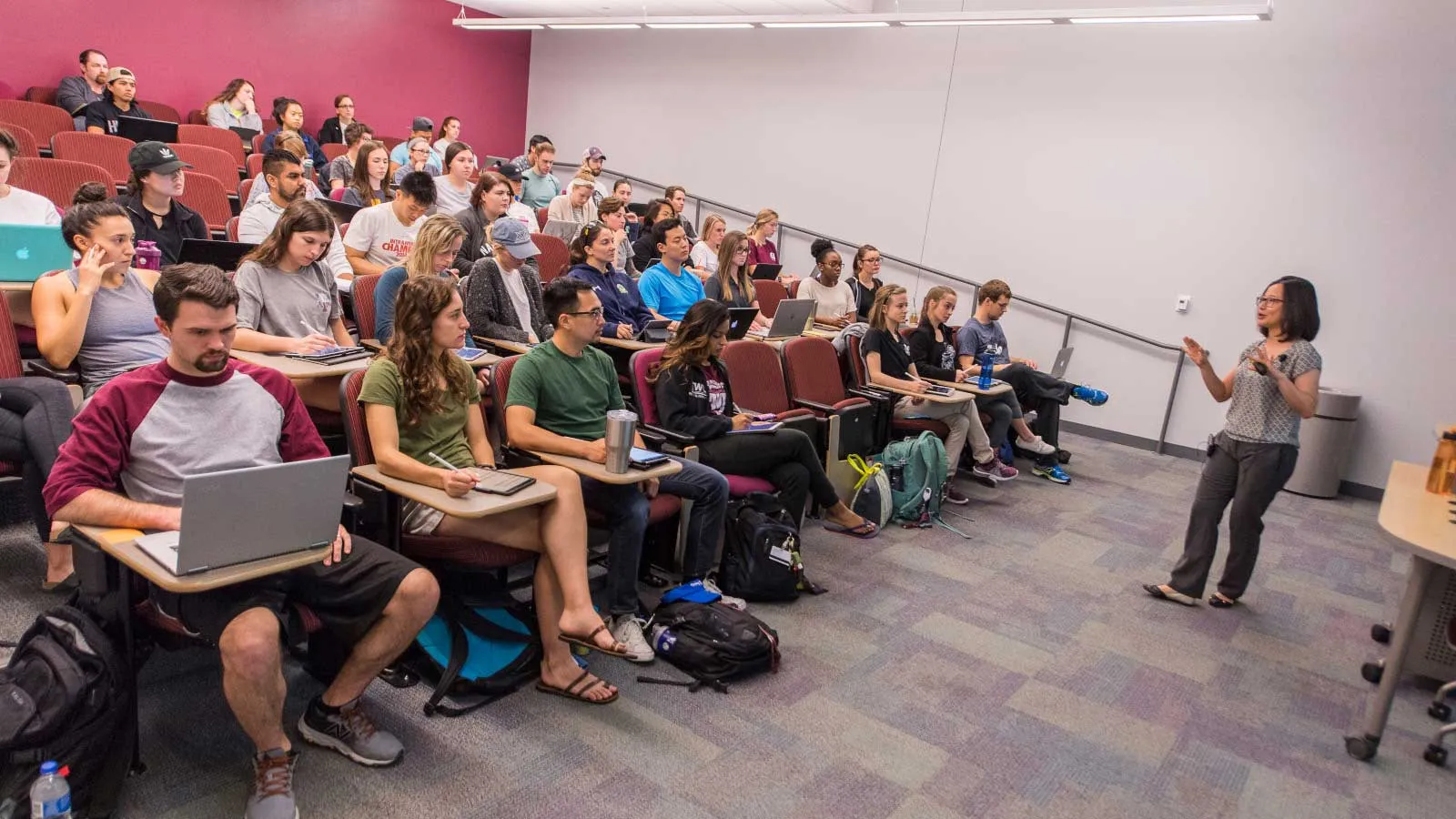 Instructor lecturing to students in classroom.