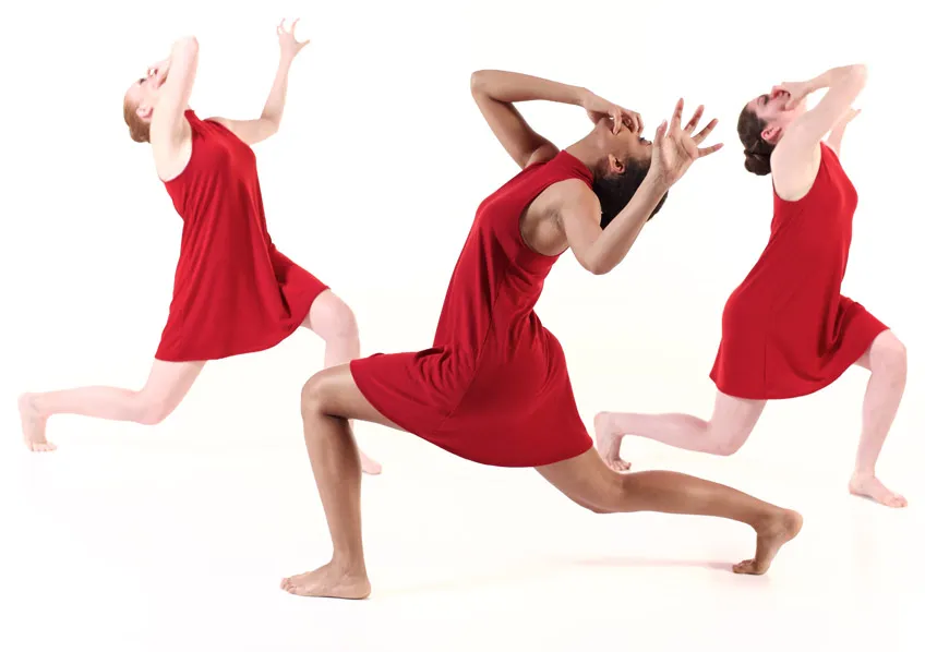 3 students in red dresses performing a modern dance 