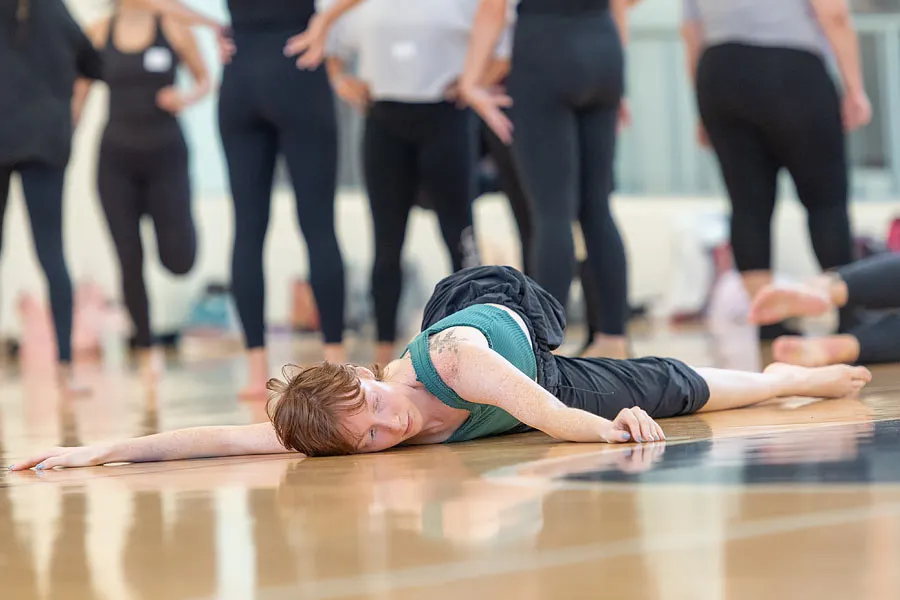 Junior Holly Griffin stretches prior to the DanceMakers audition 