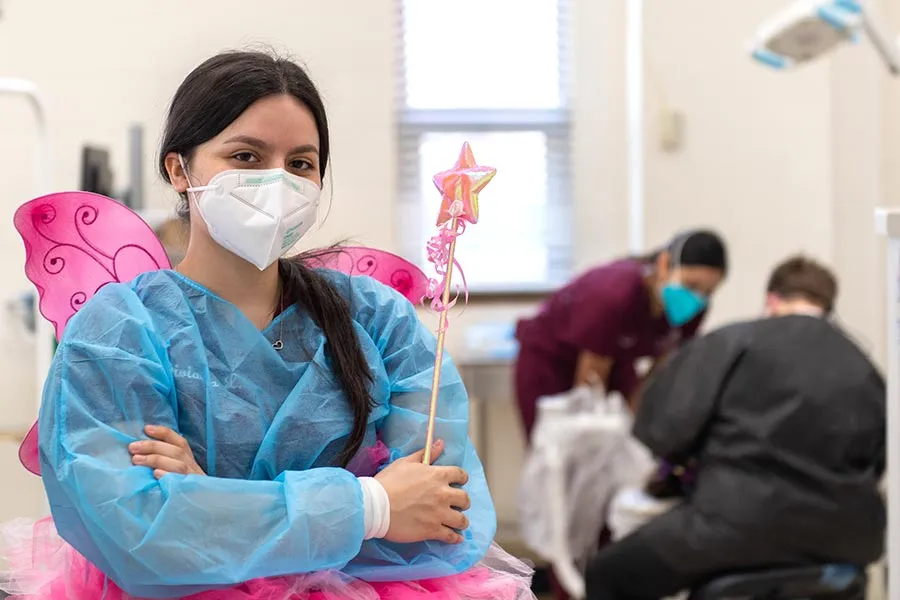 dental hygiene student in scrubs wearing a butterfly costume