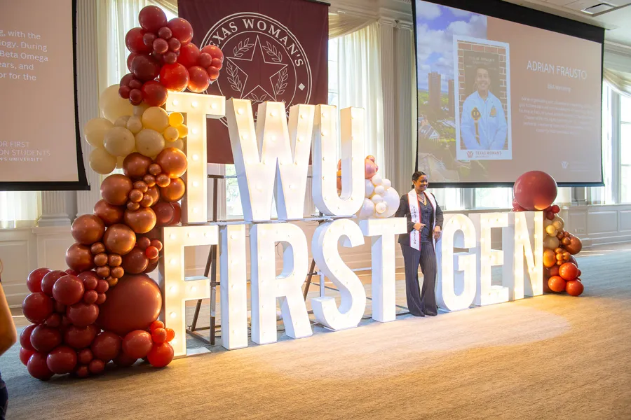 Students at First Generation graduation reception large sign