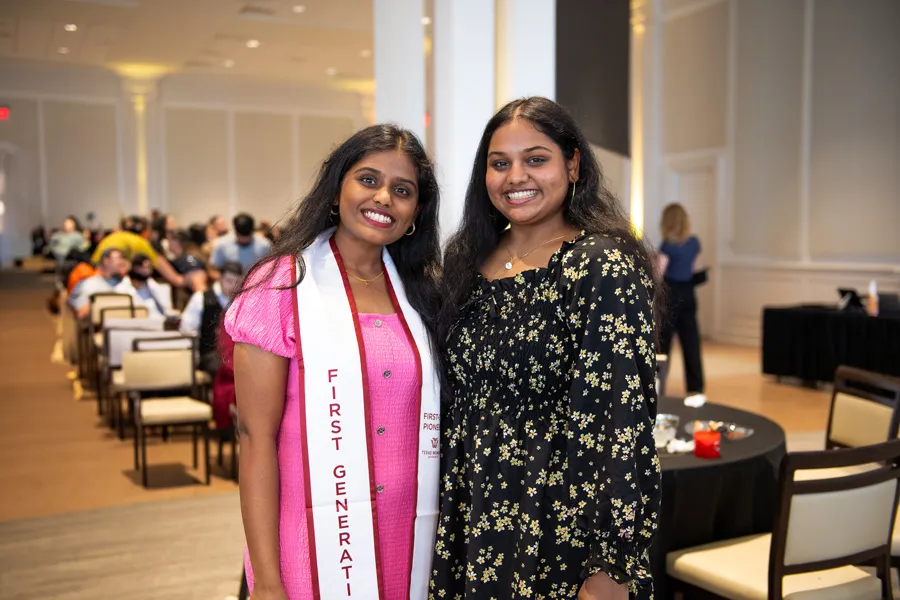 Students at First Generation graduation reception, one wearing a stole