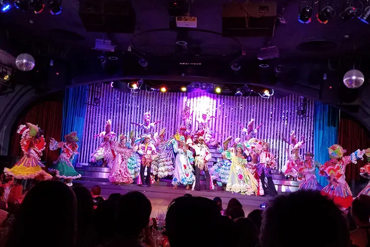 Cuban dance performance on a brightly colored stage