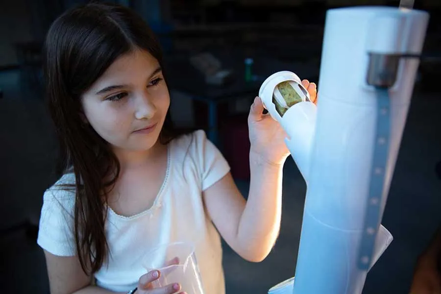 Denton ISD student examines hydroponic garden