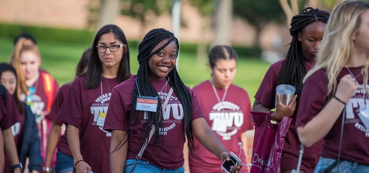 A diverse group of female students attending orientation.