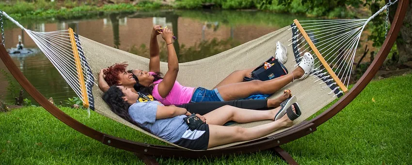 Three TWU students taking a selfie in a hammock 