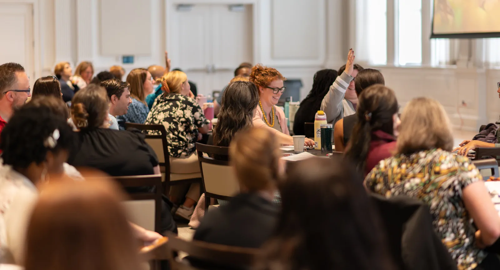 Faculty at tables during workshop