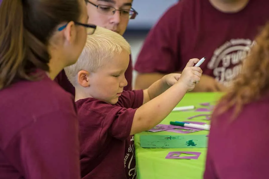 Student plays with marker