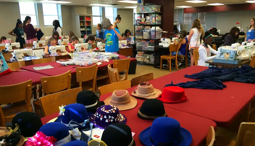 Girls working on fashion camp projects 