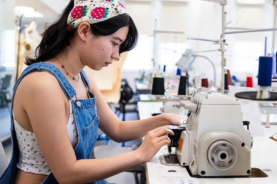 A student at a sewing machine