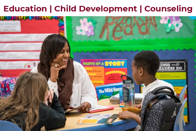 A TWU alumni teacher works with children learning to read at a table.
