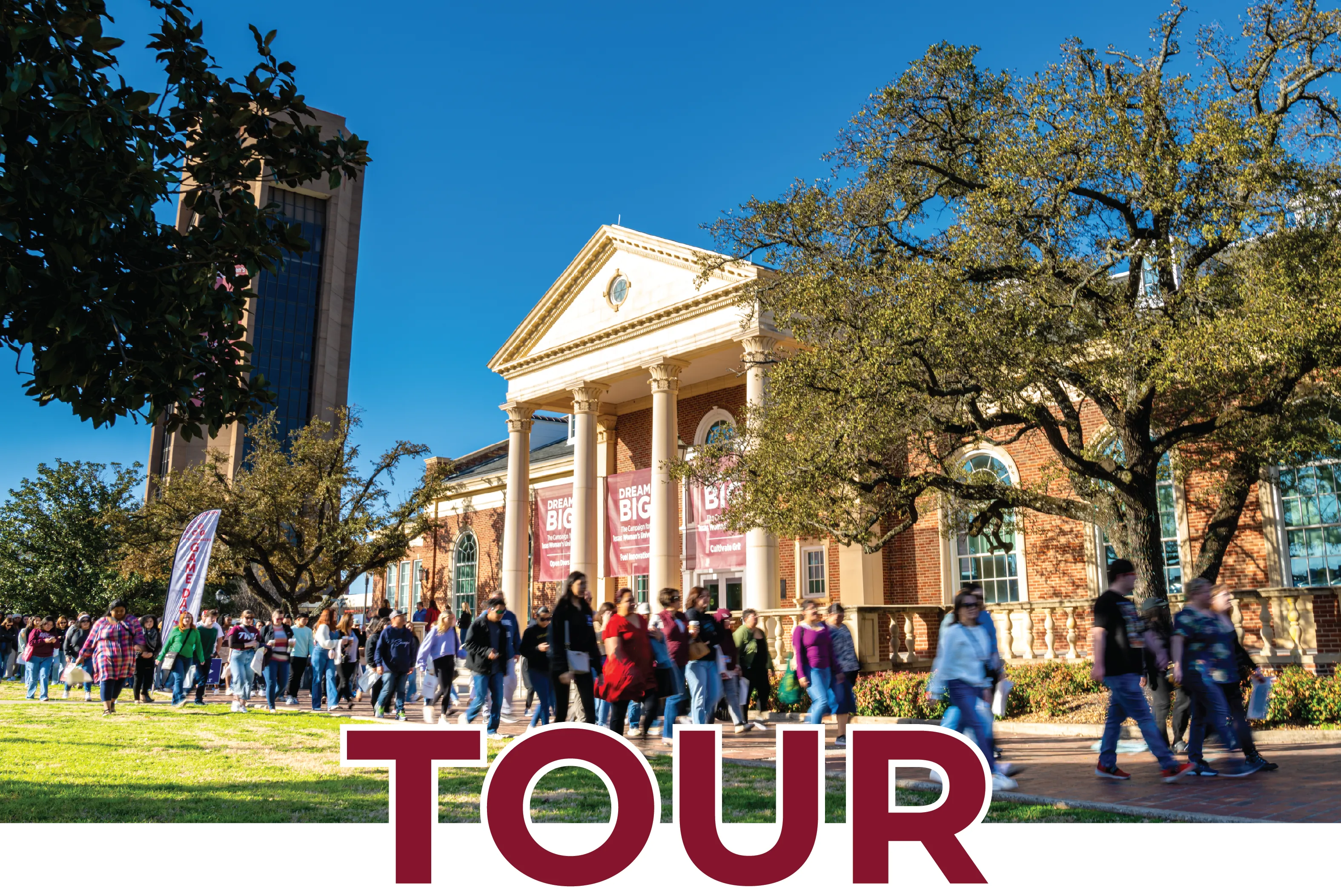 A large group takes a tour of campus in front of Hubbard Hall with graphic text on the photo that says "Tour".