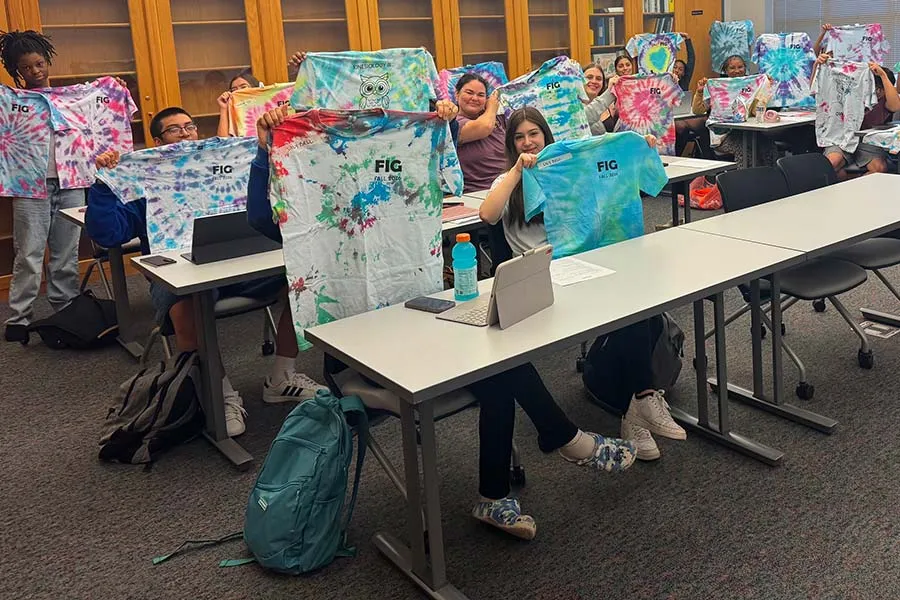 UNIV 1233 class photo all holding up tye-dye shirts