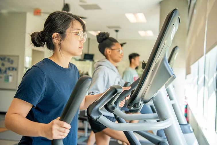 TWU Houston students work out on elliptical machines.
