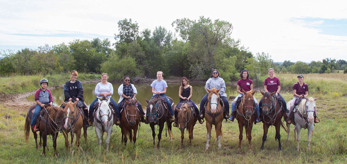 TWU foster alums group shot on horseback