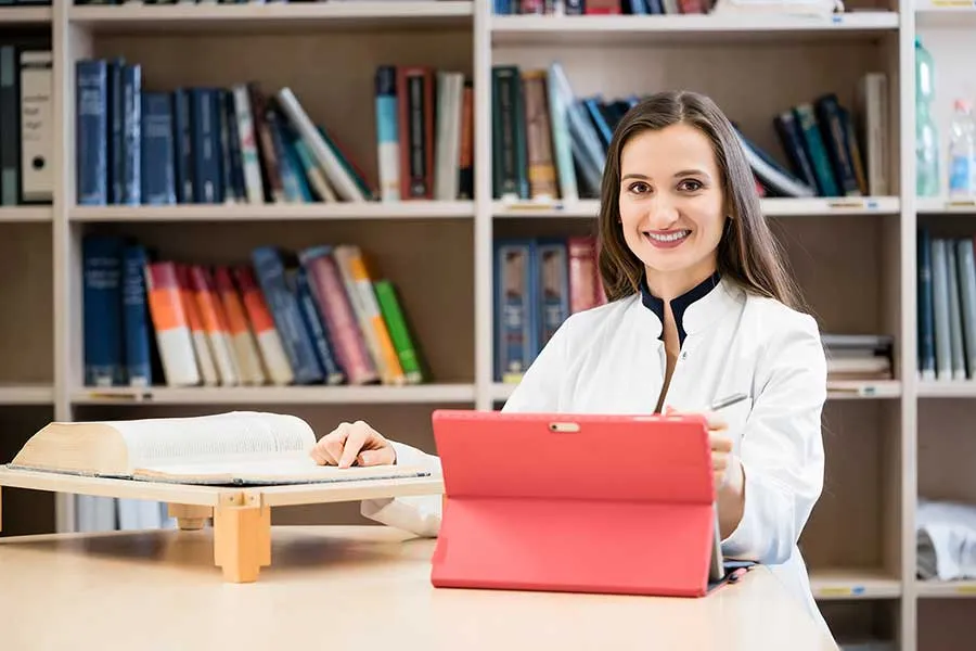 A woman works in a library setting.