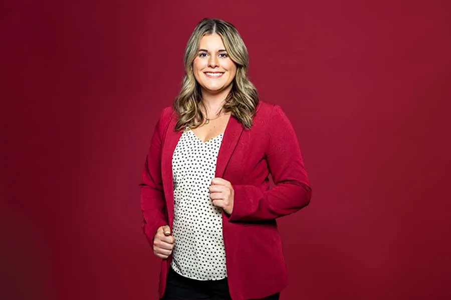 A dramatic portrait of a TWU student in business professional attire.