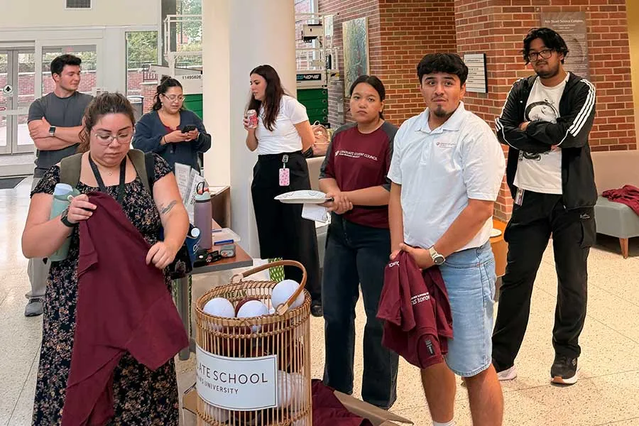Graduate Students talking to each other during event
