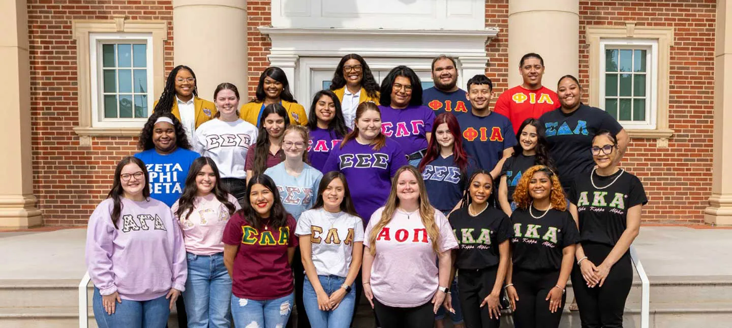 group photo of TWU students wearing t-shirts representing their various Greek organizations.