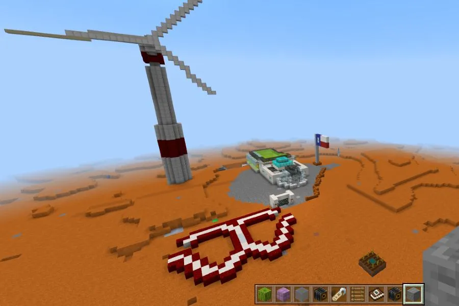 A Minecraft screenshot showing the TWU logo built into it