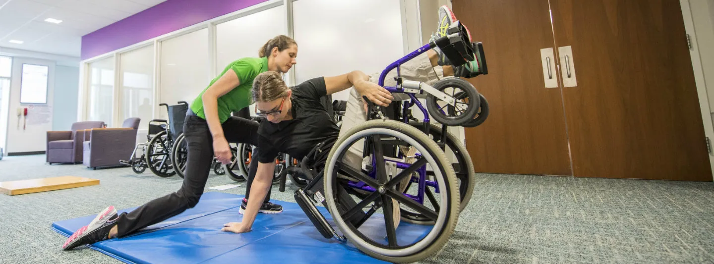 PT students demonstrating techniques with wheelchair