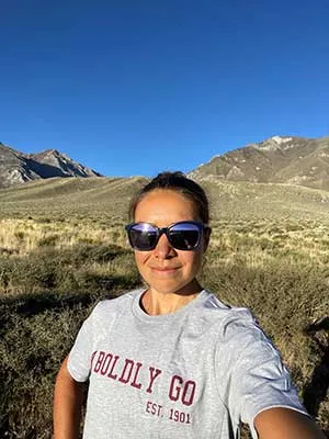 woman wearing TWU shirt in front of mountains