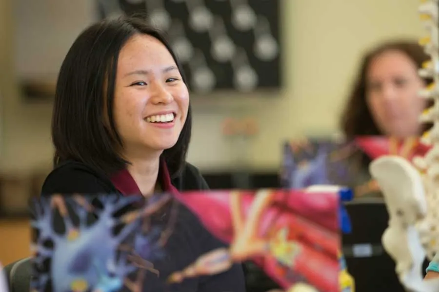 female student smiling in classroom lab