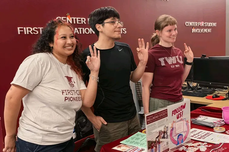 Students flashing the TWU hand sign.