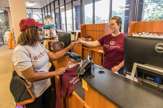 TWU student making a purchase at the campus store