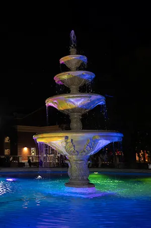 The fountain in front of Blagg-Huey Library lit up at night