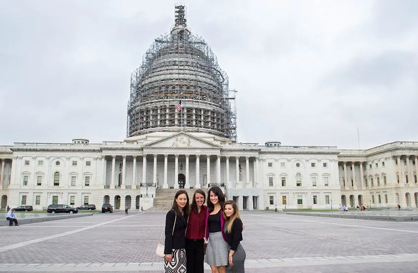Photo of four TWU students standing in front of Capitol Hill in Washington D.C. 