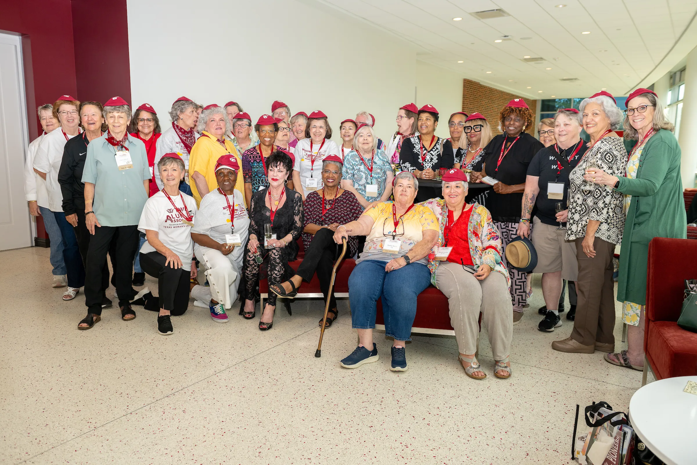 Members of the class of 1975 gather together for a group photo wearing their special 50th-year hats.