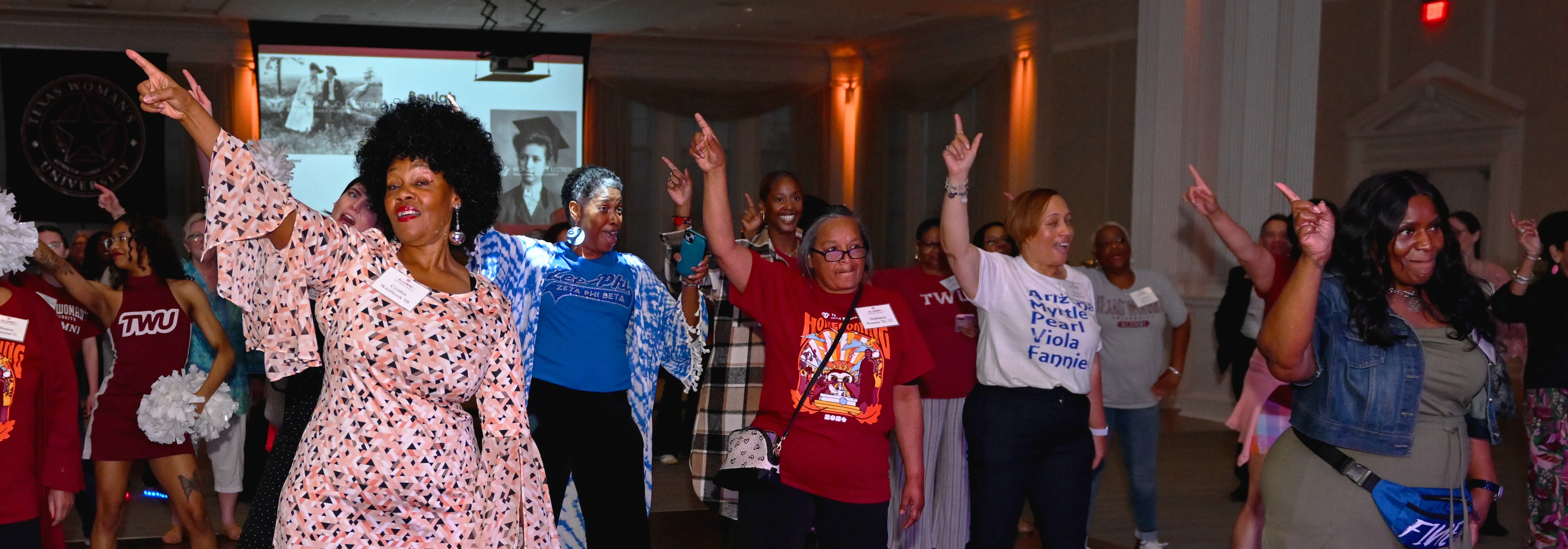 Alumni dance to a disco band at the 2024 All-Class Reunion after party.