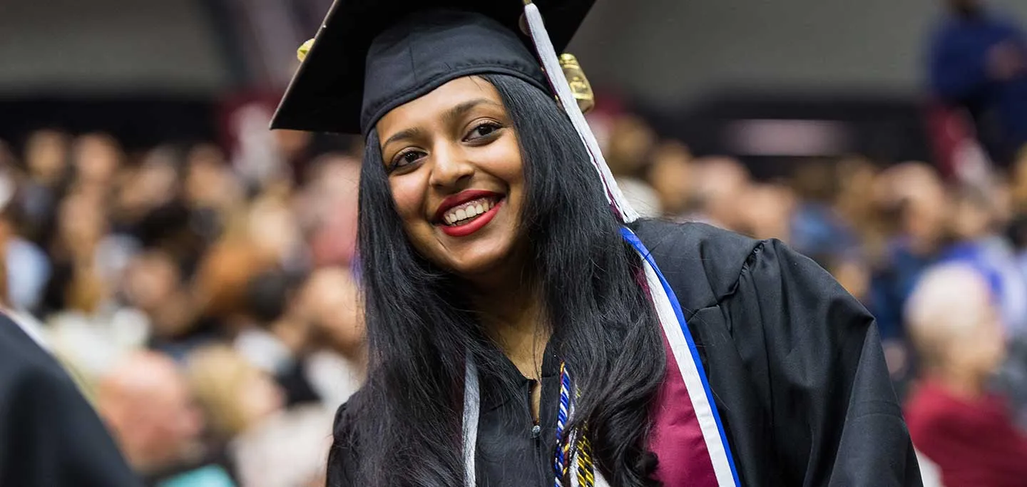 Chelsy Mani, a TWU honors student, in academic regalia during commencement.