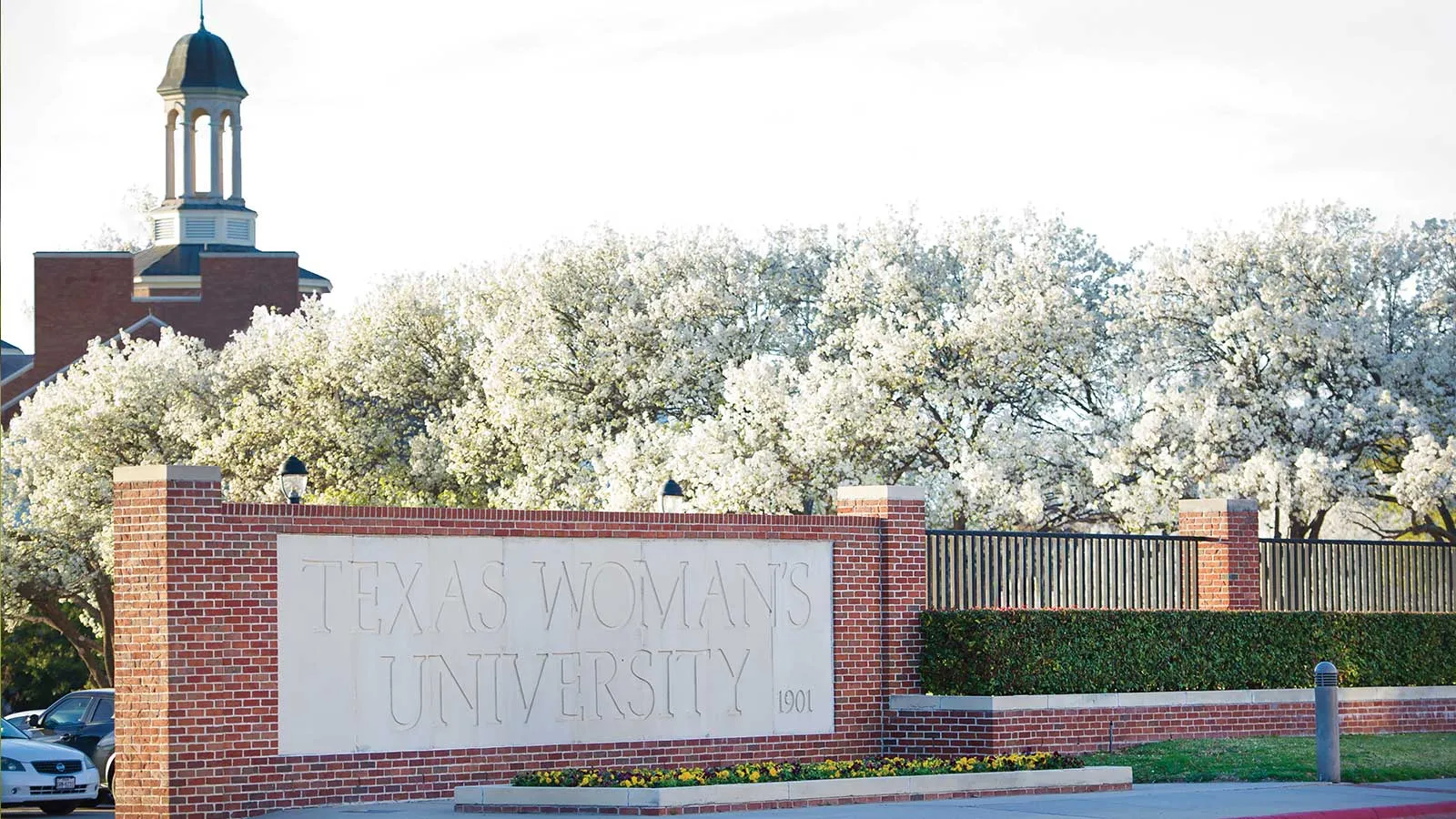 An entrance to TWU with a stone sign that reads 